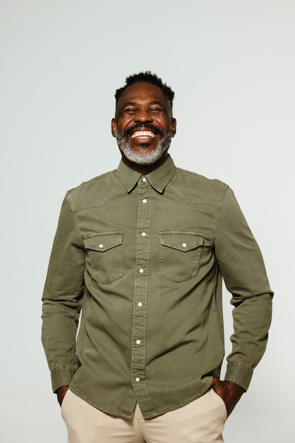 Man in olive green shirt smiling