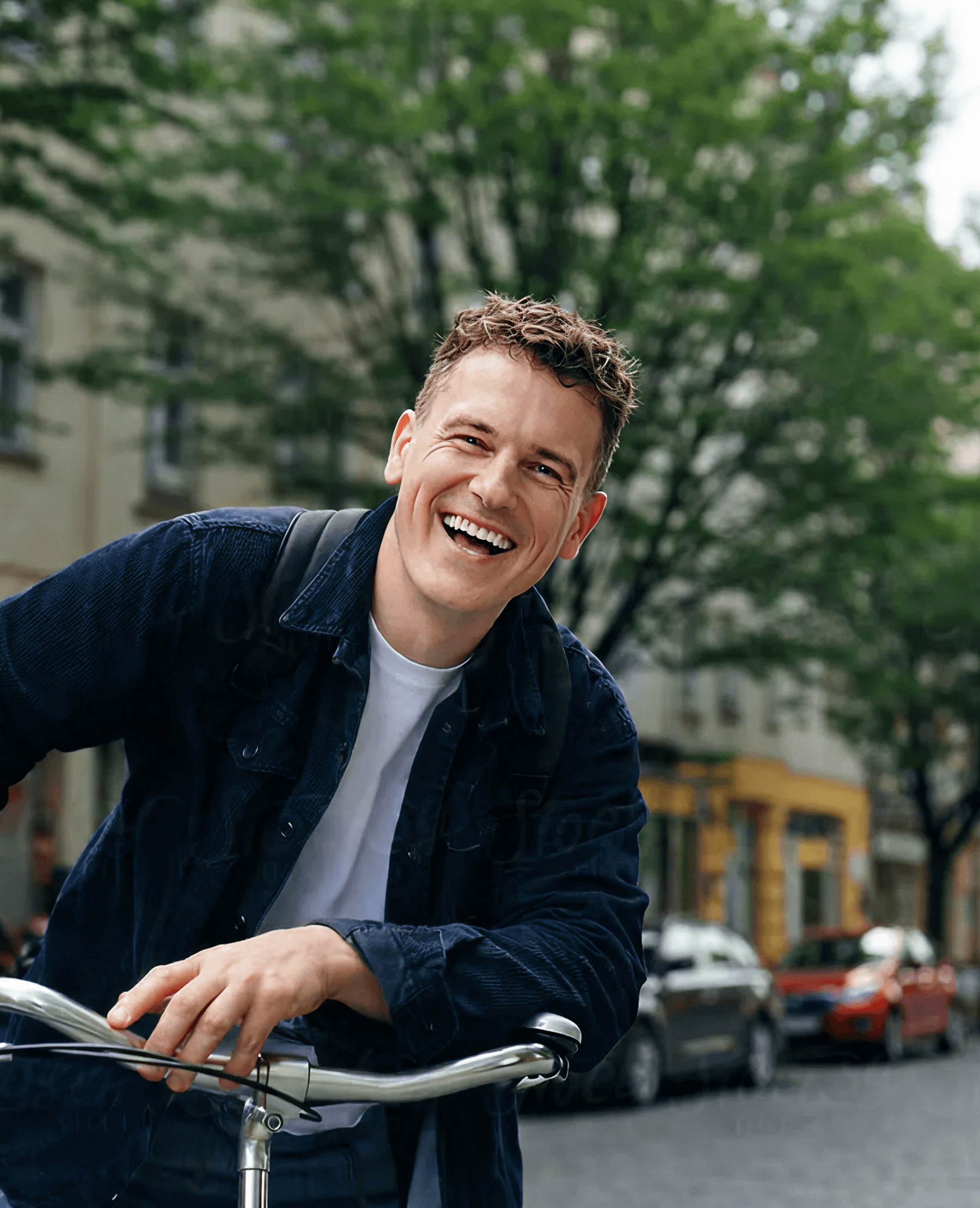 Man on bike leaning and smiling